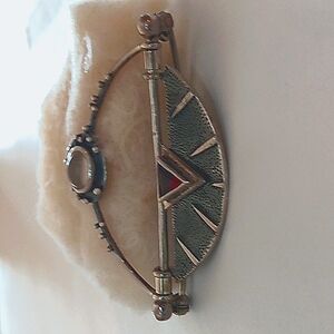 Pin with silver metal, and small garnet & moonstone gems.